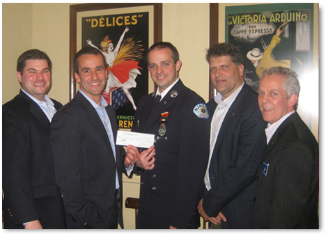 Mineola Lions members stand with donation to community organizations