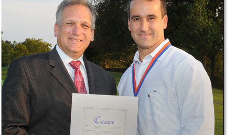 Mineola Lions president Chris Lopez recognized for dedicated service to community by county executive Ed Mangano.