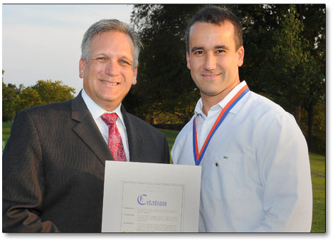 Mineola Lions president Chris Lopez recognized for dedicated service to community by county executive Ed Mangano.